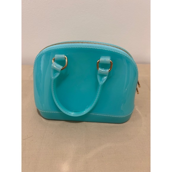 Handbags - Turquoise handbag is likely a jelly-style mii purse